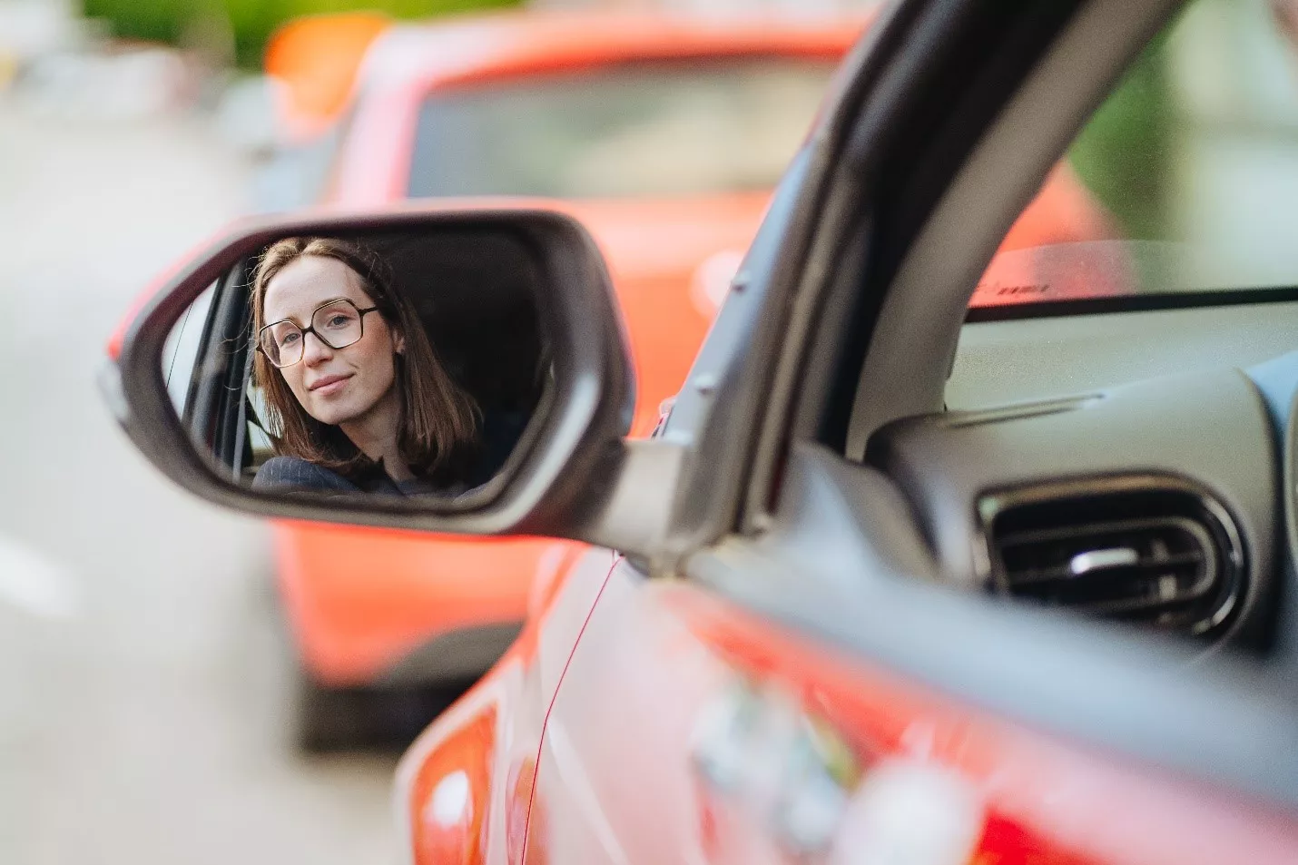 Person looking in the rear-view mirror of a Poppy car